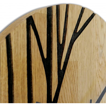 Modern wooden wall clock with a black motif and contrasting hands.