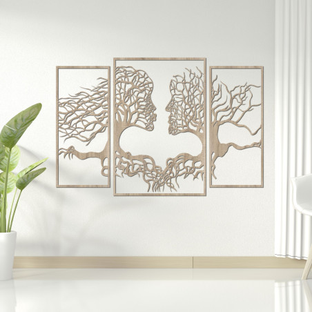 Wooden wall painting of faces and trees depicts the connection between man and nature