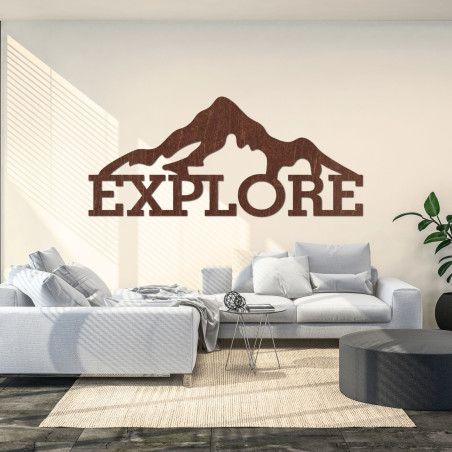 Carved wood image of a mountain - EXPLORE