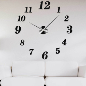 Adhesive wall clock made of black plexiglass on a white wall