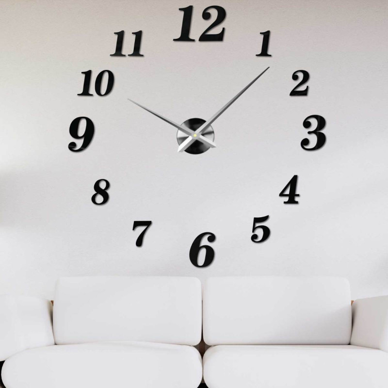 Adhesive wall clock made of black plexiglass on a white wall