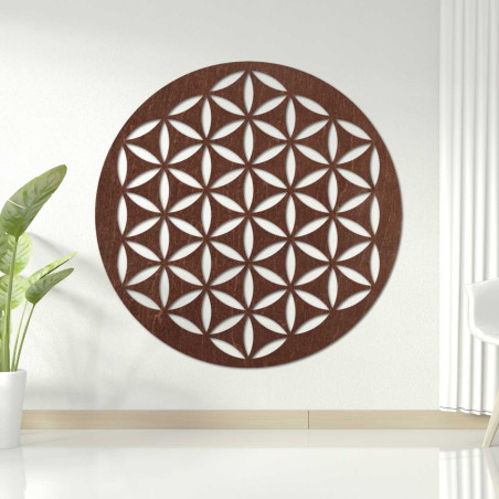 Wooden wall decoration with a geometric flower of life pattern displayed on a light wall.