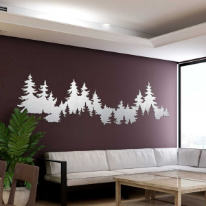 Close-up view of a forest silhouette made of wood mounted on a white wall.