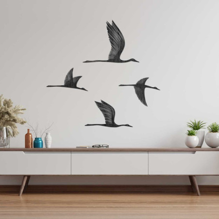 A view of wooden birds that appear light and airy on the wall
