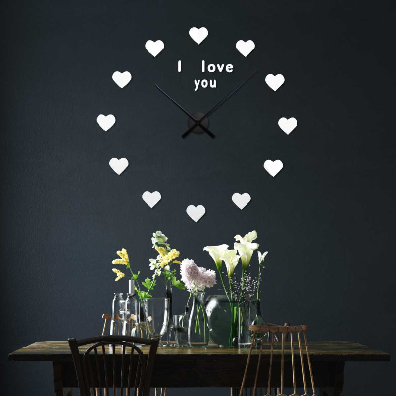 Detail of a watch face with hearts instead of classic time markers.