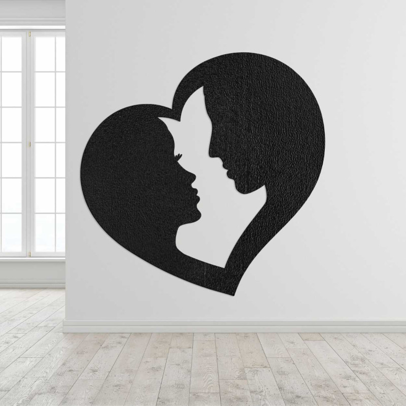 A simple wooden decoration with a silhouette of a couple enclosed in a heart.