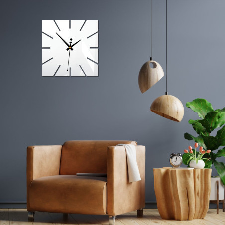 Decorative wall clock with white dial on black background