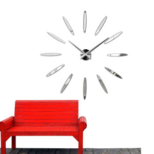 Wall clock with large gold indexes and silver hands, glued directly to the wall