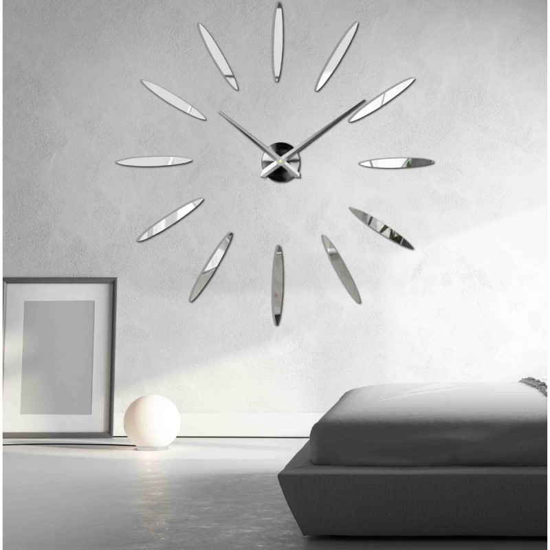 Designer clock made of gold plexiglass with a central black movement and delicate hands.