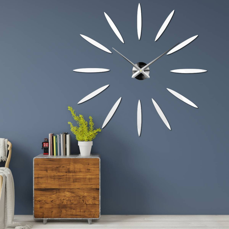 Modern clock with twelve mirror elements in gold color, without numbers.