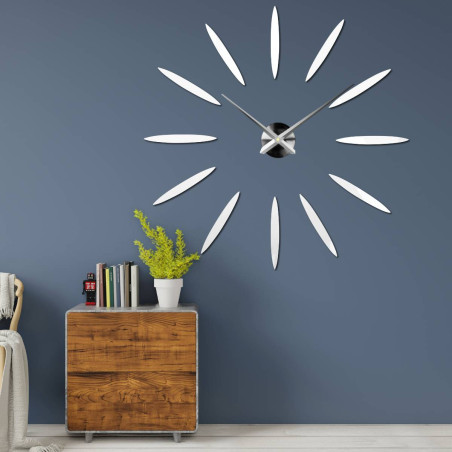 Modern clock with twelve mirror elements in gold color, without numbers.
