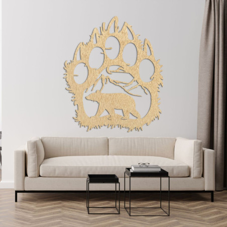 Carved shape of a large bear paw with four claws and a detail of a landscape with mountains and a bear in the middle. Carved shape of a large bear paw with four claws and a detail of a landscape with mountains and a bear in the middle.