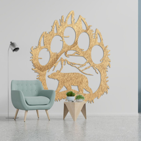 A wooden image of a bear footprint, inside of which is carved the silhouette of a bear walking under the mountains. A wooden image of a bear footprint, inside of which is carved the silhouette of a bear walking under the mountains.