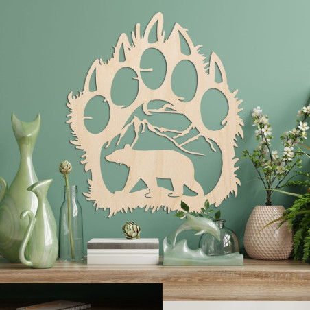 A contrasting silhouette of a bear track, inside which a mountain range and the figure of a bear walking forward can be seen. A contrasting silhouette of a bear track, inside which a mountain range and the figure of a bear walking forward can be seen.