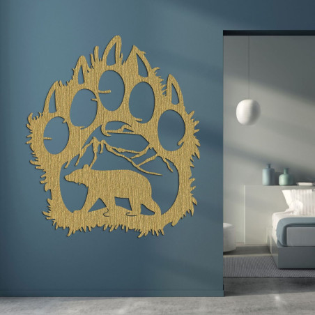 Golden Wooden silhouette of a large bear paw with an internal motif of nature: mountains, trees and the bear itself. Golden Wooden silhouette of a large bear paw with an internal motif of nature: mountains, trees and the bear itself.