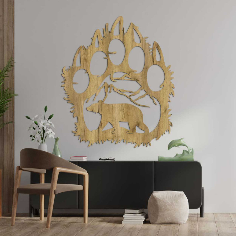 Hand-carved decoration depicting a bear walking under a mountain range.