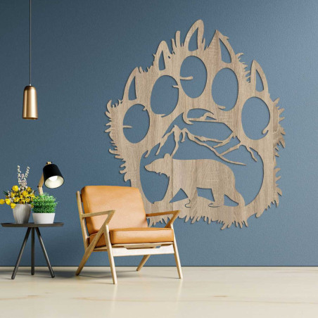 A carved nature motif enclosed in the dramatic silhouette of a bear's paw.