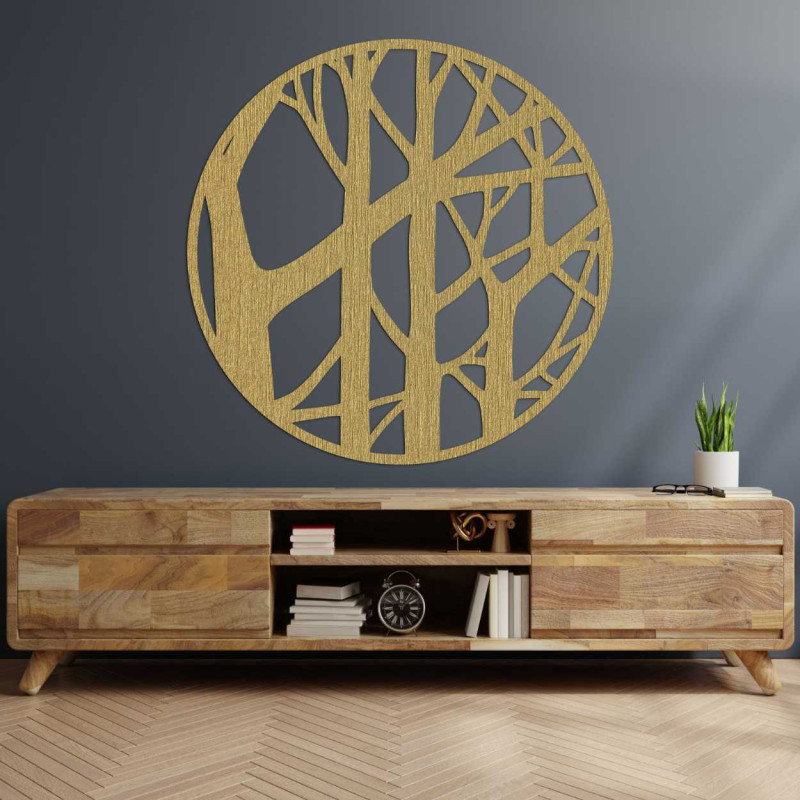 Round wooden decoration with carved tree motif on a dark wall