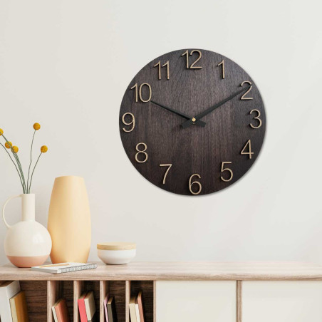 A wooden decorative element in the shape of a clock with carved numbers and a clean style.