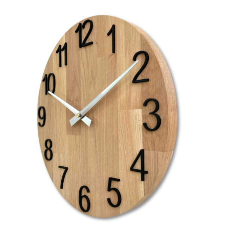 Carved wooden clock with a simple dial and minimalist design. Carved wooden clock with a simple dial and minimalist design.
