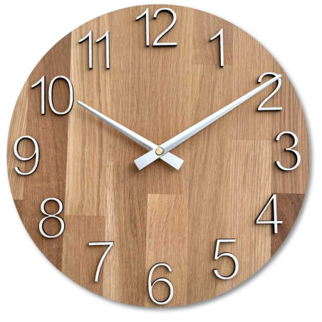 Round clock with a decorative cutout in the center and a delicate wood pattern. Round clock with a decorative cutout in the center and a delicate wood pattern.