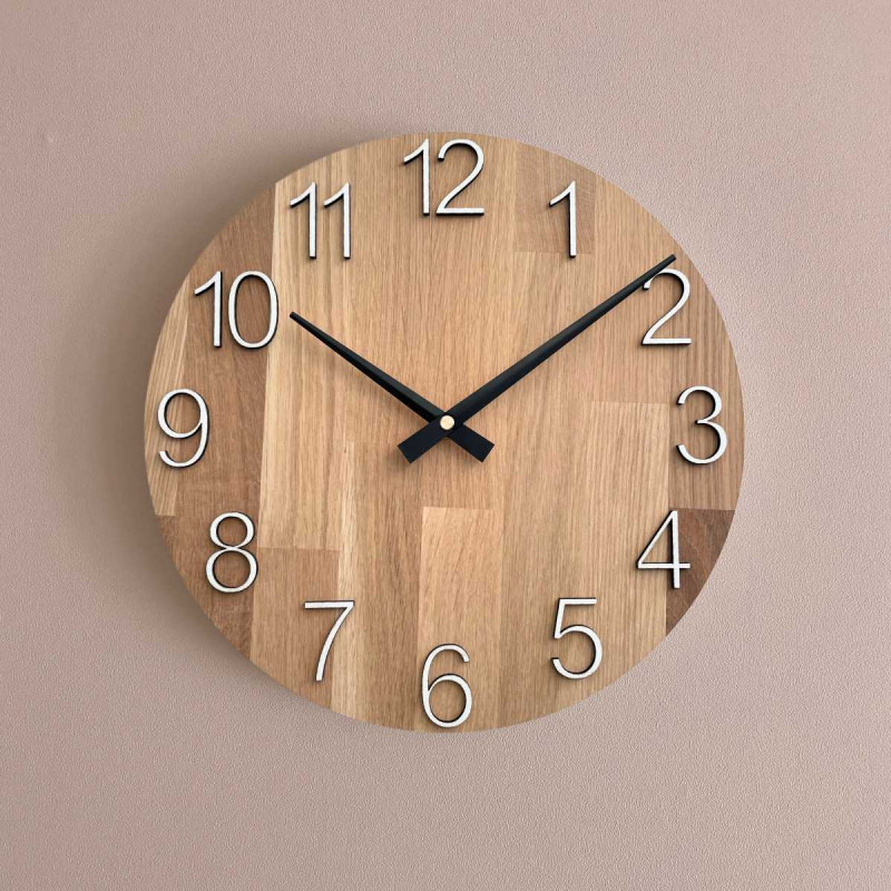 Natural wooden clock with a simple design and thin hands.