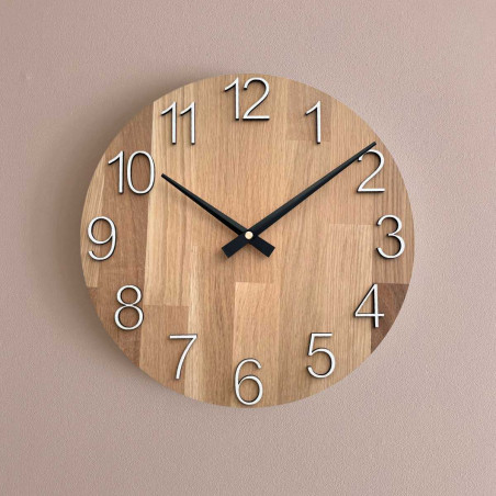 Natural wooden clock with a simple design and thin hands.