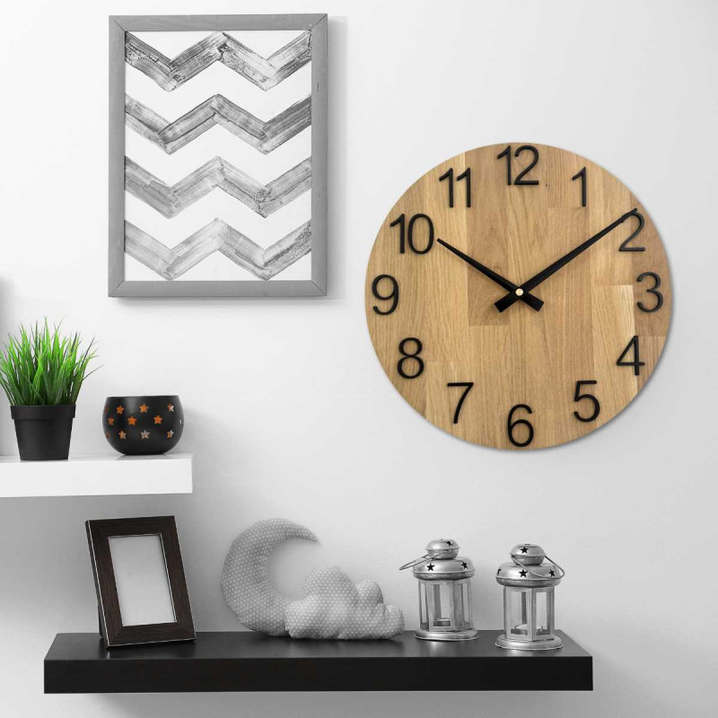 Carved wooden clock with a simple dial and minimalist design.