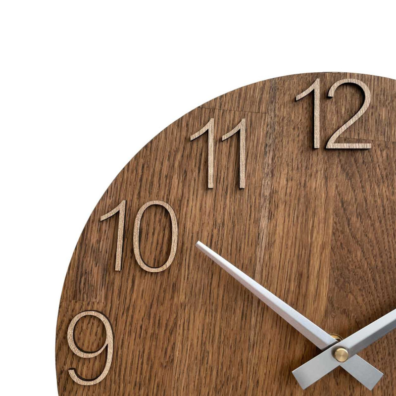 Wooden wall clock with a circular shape and a subtle natural motif.