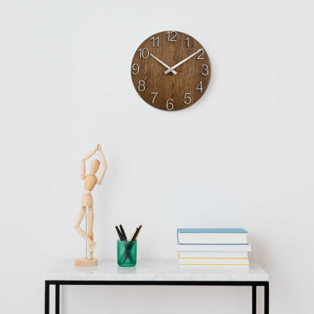 Round clock made of natural wood with contrasting metal hands.