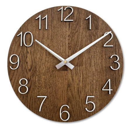 Wooden clock with a symmetrical shape and a cutout inspired by motifs from nature.