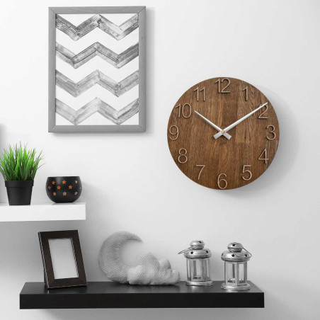 Carved wooden clock with a simple dial and minimalist design.