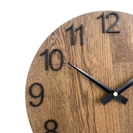 Carved wooden clock with a simple dial and minimalist design.