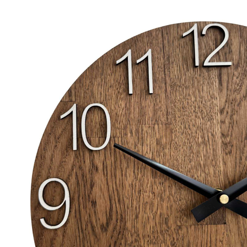 Carved wooden clock with a simple dial and minimalist design.