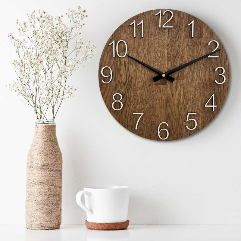 Round clock made of natural wood with contrasting metal hands.
