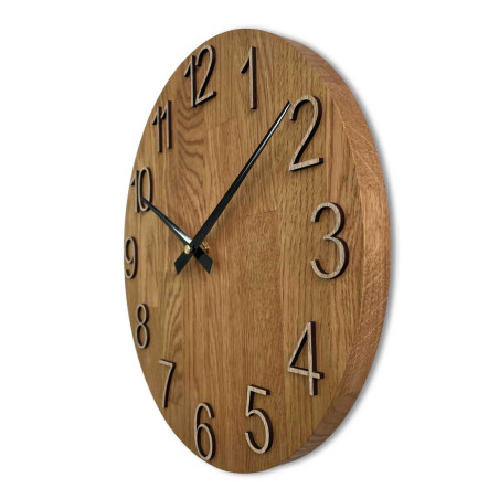 Carved wooden clock with a simple dial and minimalist design.