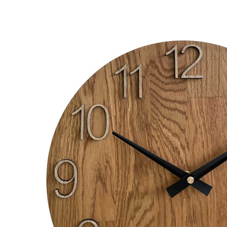 Round clock made of natural wood with contrasting metal hands.