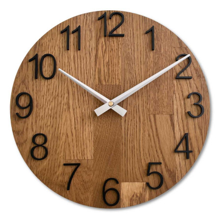 Clock made of solid wood with engraved numbers and a natural pattern. Clock made of solid wood with engraved numbers and a natural pattern.