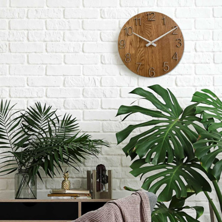 Round clock with a decorative cutout in the center and a delicate wood pattern. Round clock with a decorative cutout in the center and a delicate wood pattern.