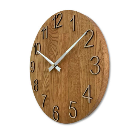 Wooden wall clock with a circular shape and a subtle natural motif. Wooden wall clock with a circular shape and a subtle natural motif.