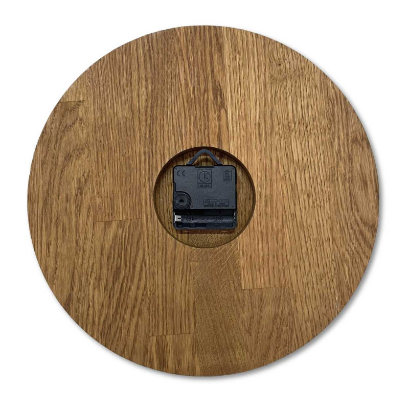 Carved wooden clock with a simple dial and minimalist design.