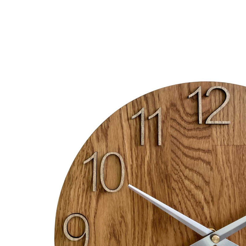 Round clock made of natural wood with contrasting metal hands.