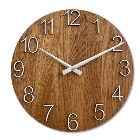 Clock made of solid wood with engraved numbers and a natural pattern. Clock made of solid wood with engraved numbers and a natural pattern.