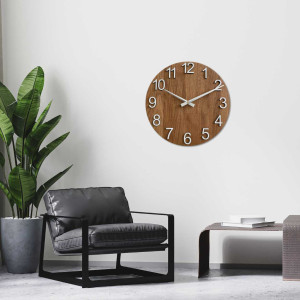 Wooden wall clock with a circular shape and a subtle natural motif. 2