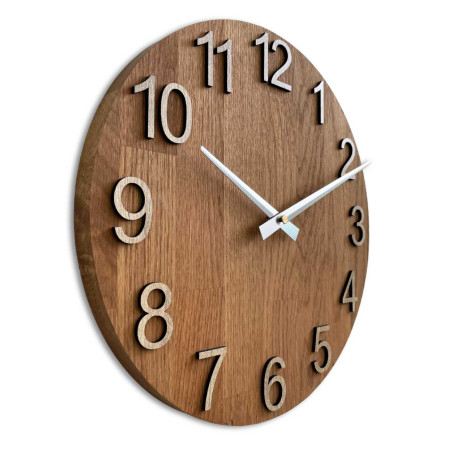 Wooden clock with a symmetrical shape and a cutout inspired by motifs from nature.