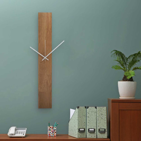 Modern clock made of solid wood with black and silver hands on the central axis. Modern clock made of solid wood with black and silver hands on the central axis.