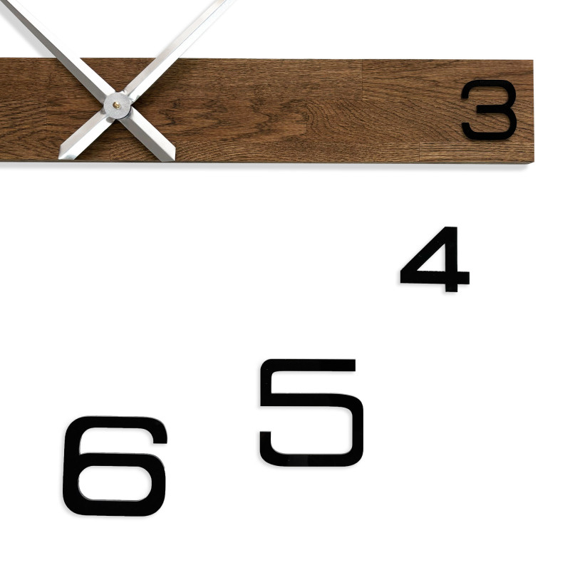 Wooden clock with an unconventional arrangement of black numerals around a central wooden bar.