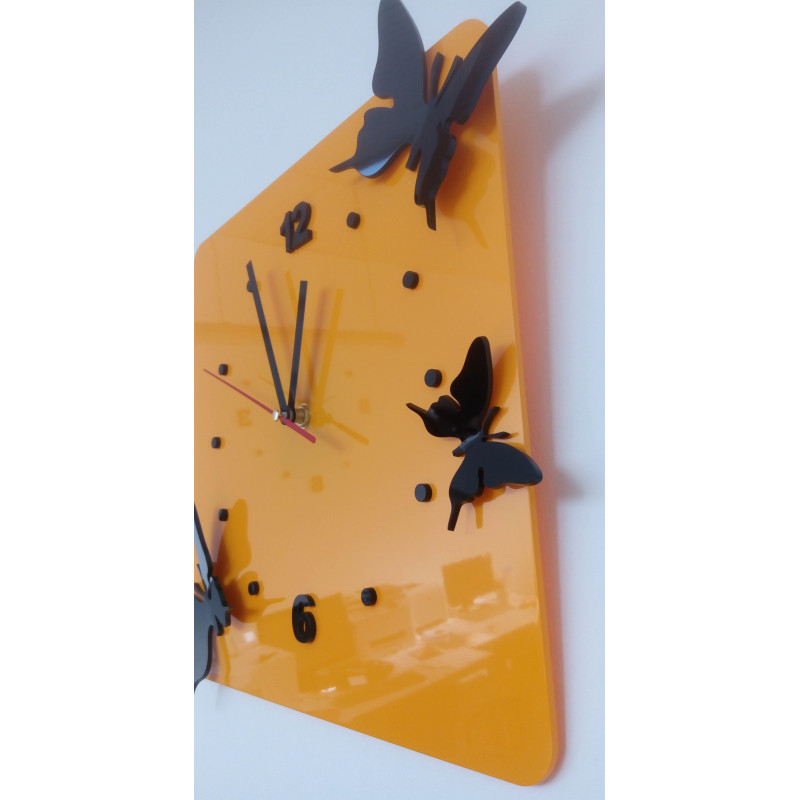 Modern wall clock made of plexiglass. Trendy clock on the wall as a gift. X-momo clocks. PMMA