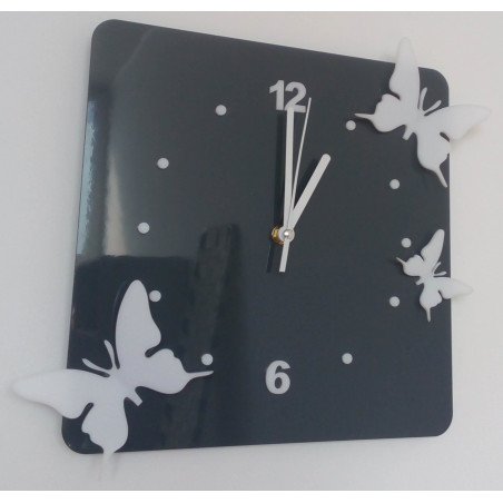 Modern wall clock made of plexiglass. Trendy clock on the wall as a gift. X-momo clocks. PMMA