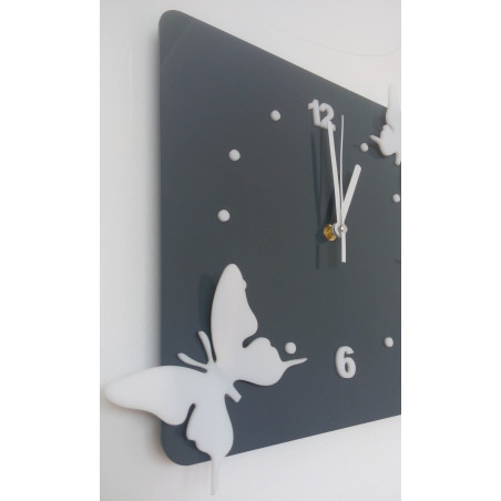 Modern wall clock made of plexiglass. Trendy clock on the wall as a gift. X-momo clocks. PMMA
